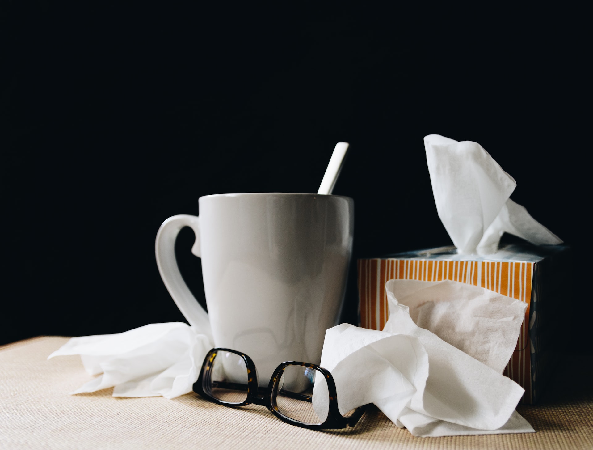 mug, glasses, and tissues for seniors to stay healthy in winter