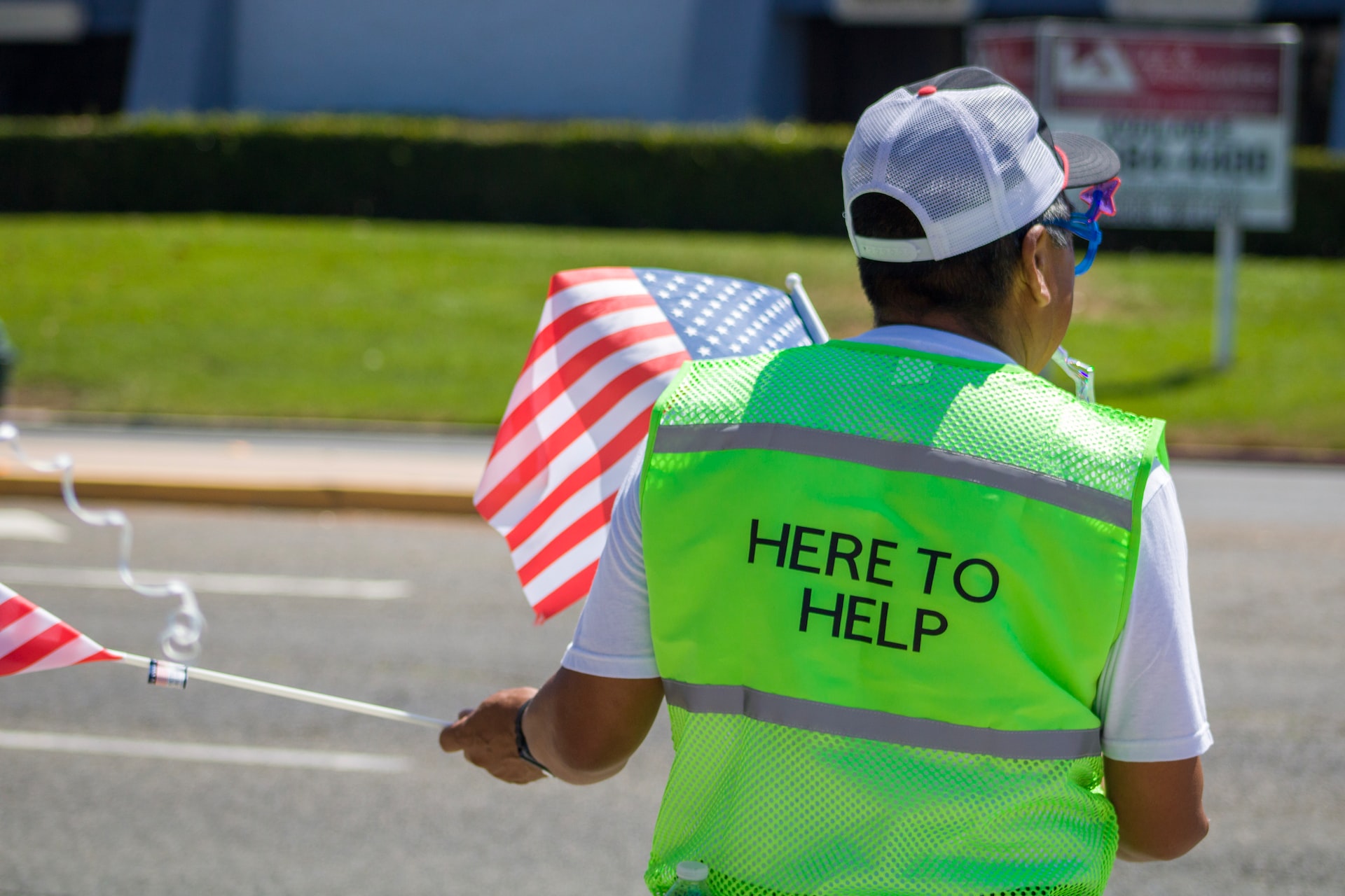 person in green vest volunteers in their community