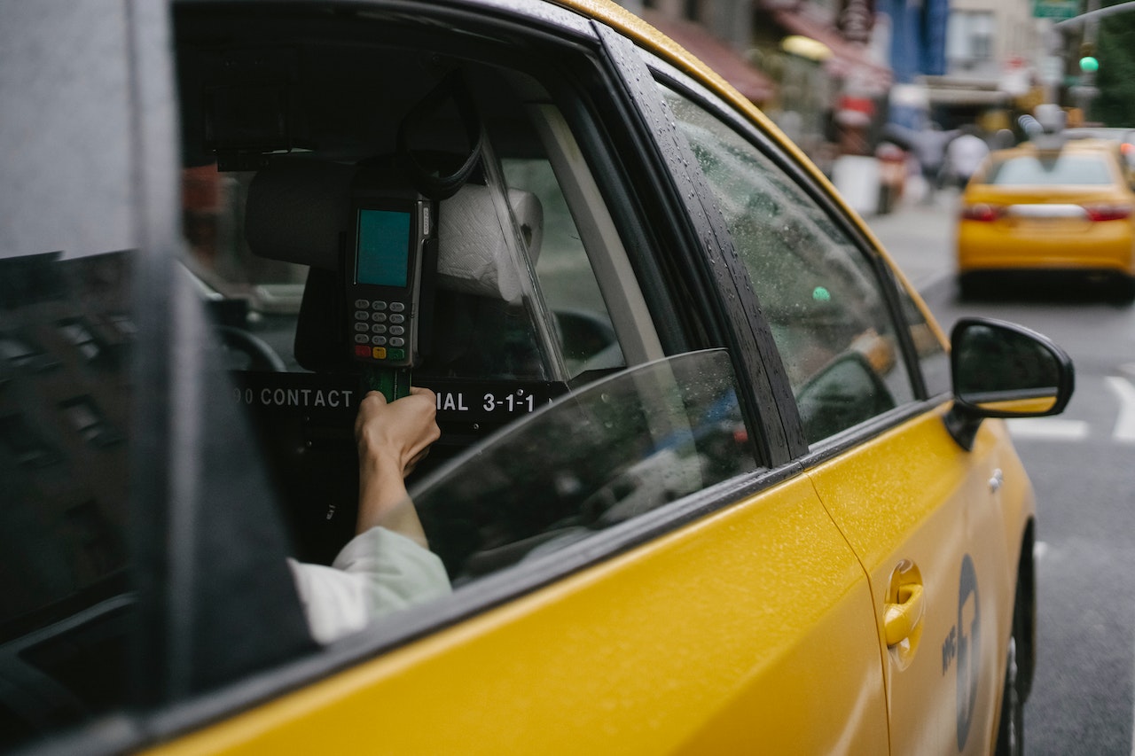 man uses cashless system in taxi